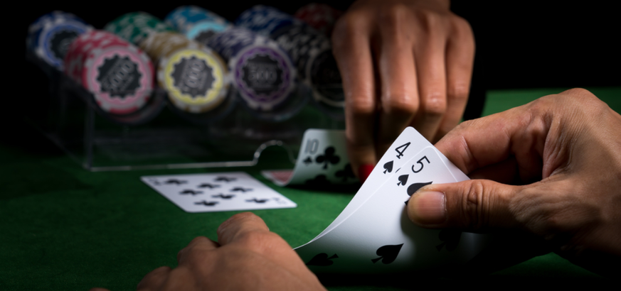 A player looks at his hand to see what cards he has.