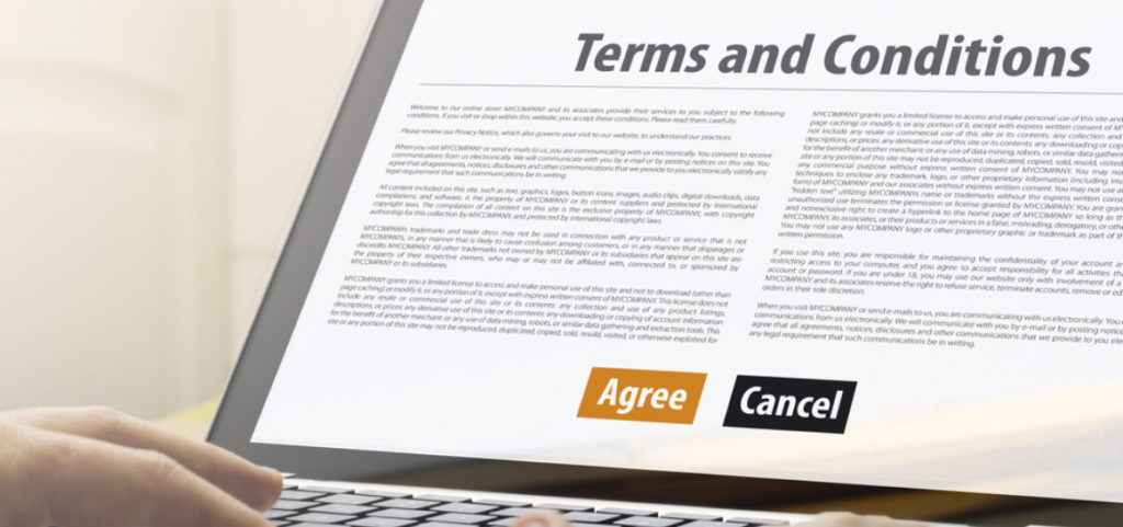 Terms and Conditions page displayed on laptop screen with 'Agree' and 'Cancel' buttons below.