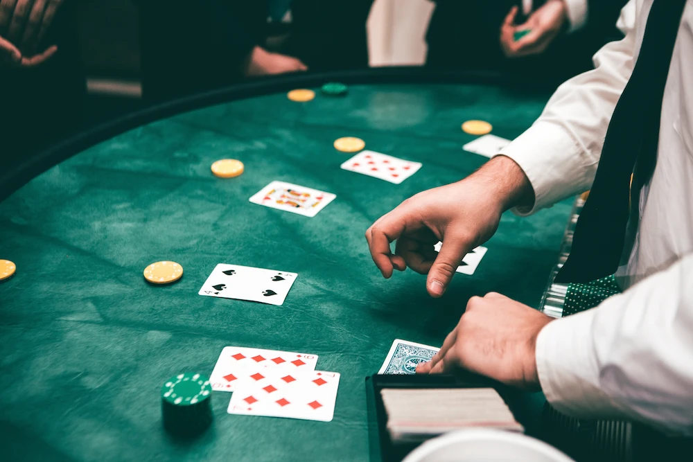 A dealer dealing the cards on a blackjack table