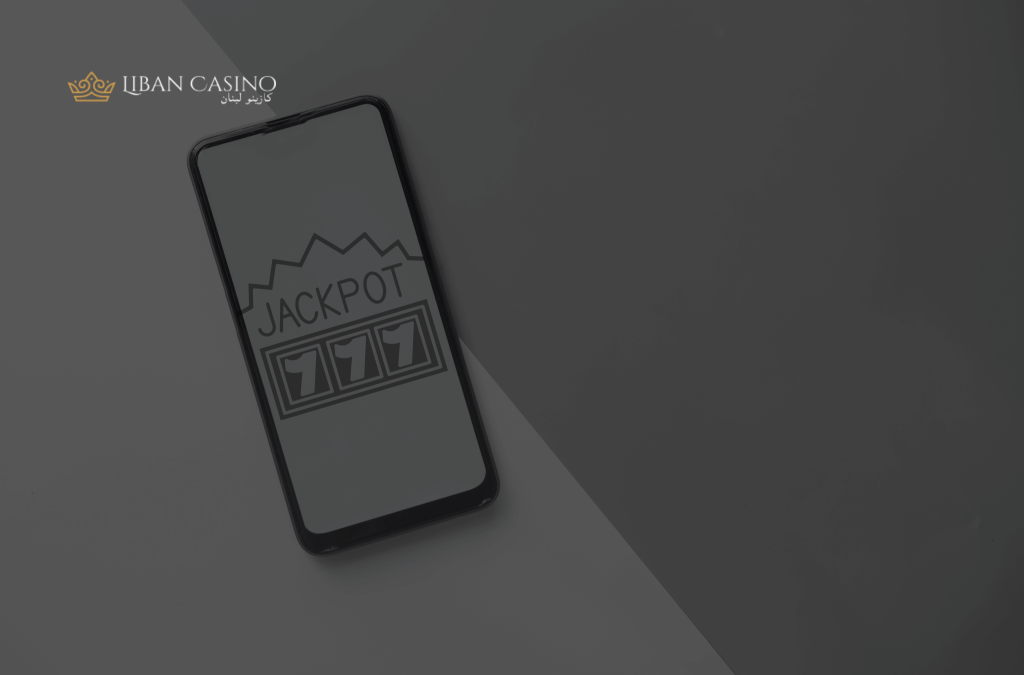Mobile phone showing 777 and jackpot writing on the screen.