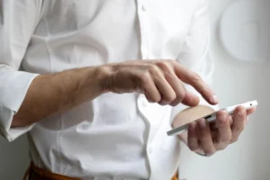 Person holding a white smartphone